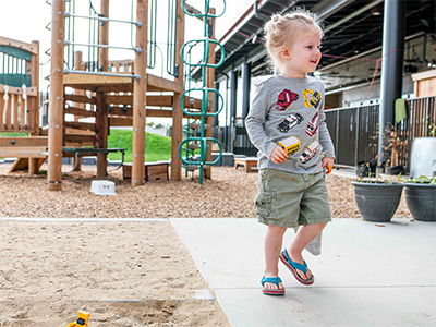 child outside by play structure